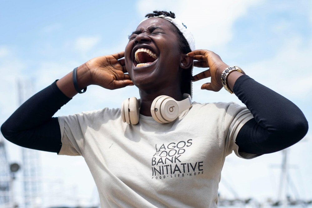 Black man wearing headphones and a charity t-shirt