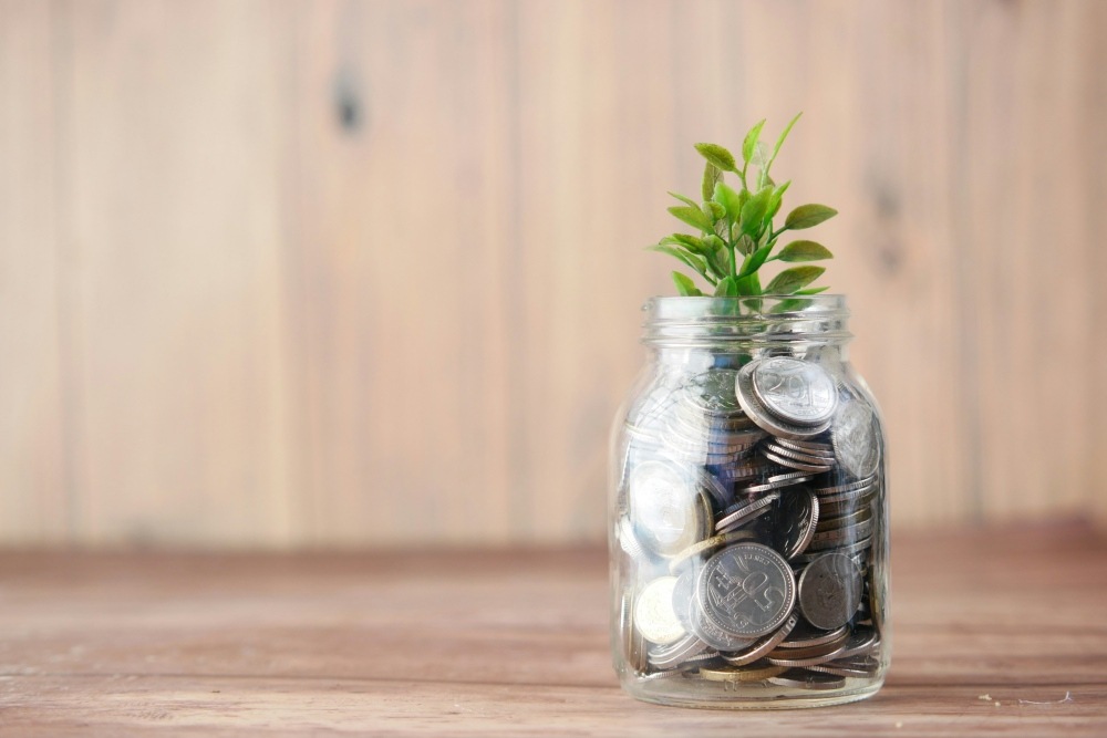 Fundraising jar with coin donations