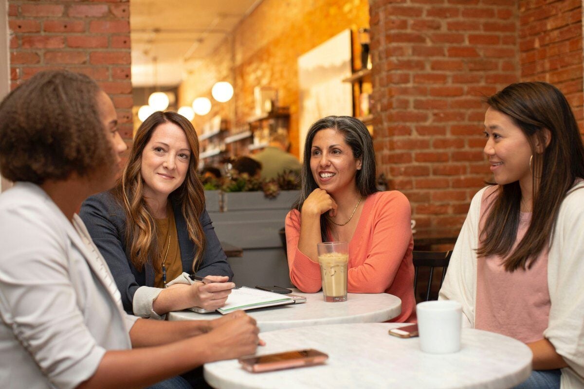 Group of women talking around table