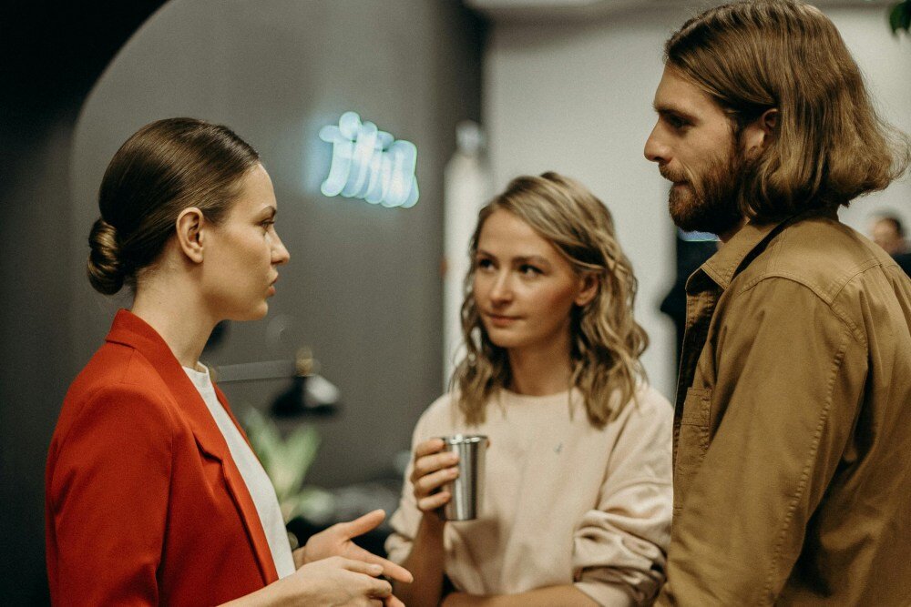 Three people talking at an event