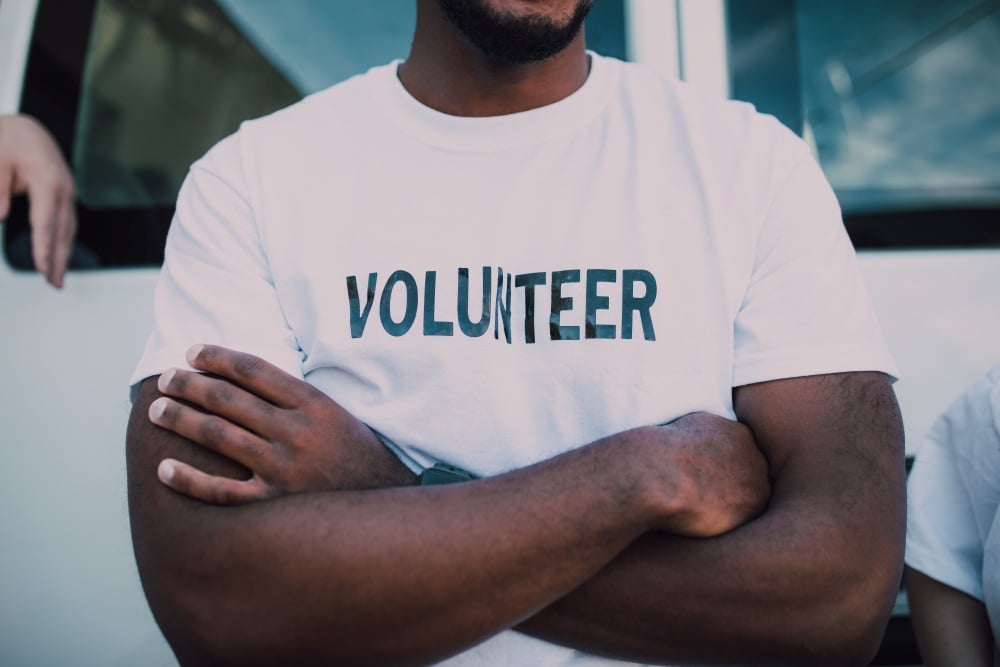 Volunteer with arms crossed