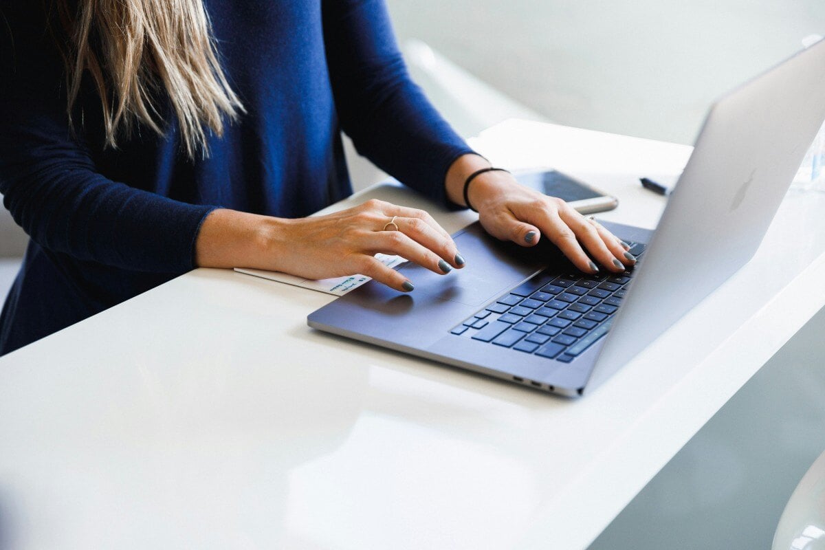 Woman typing up silent auction item descriptions