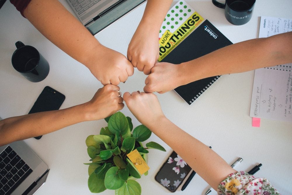 team putting hands together