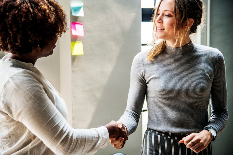 convert-auction-attendees-into-donors-women-shaking-hands